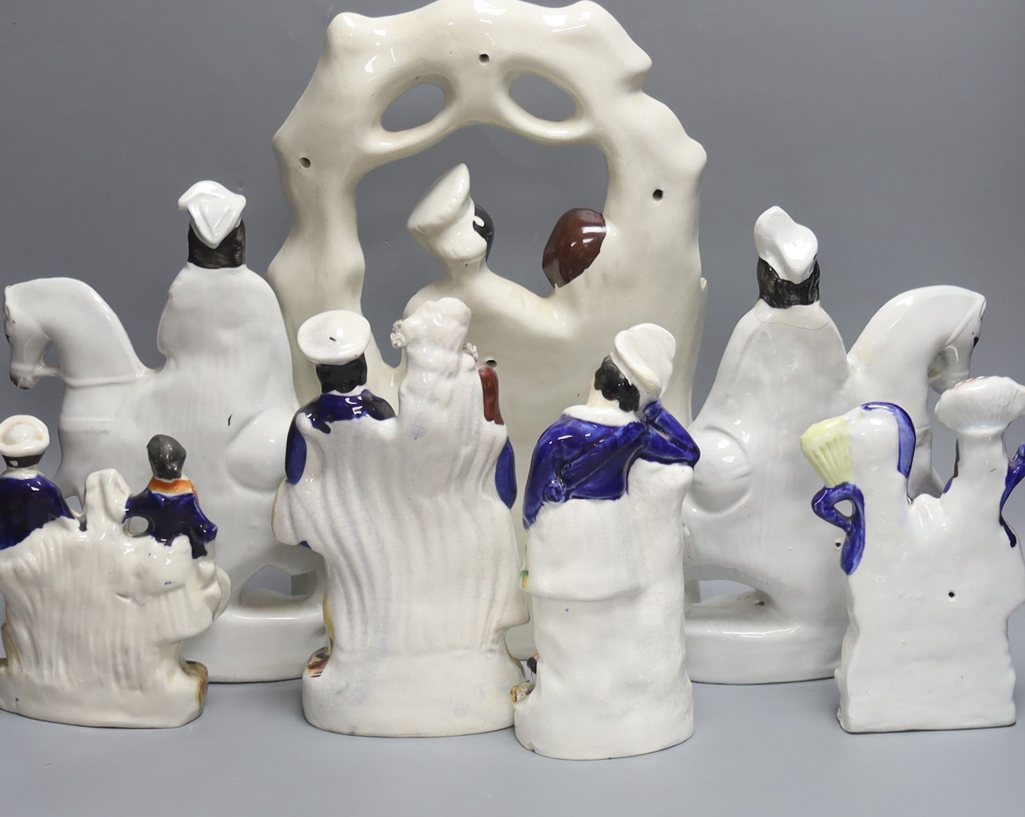 A group of seven Staffordshire pottery flatbacks, tallest 36 cm